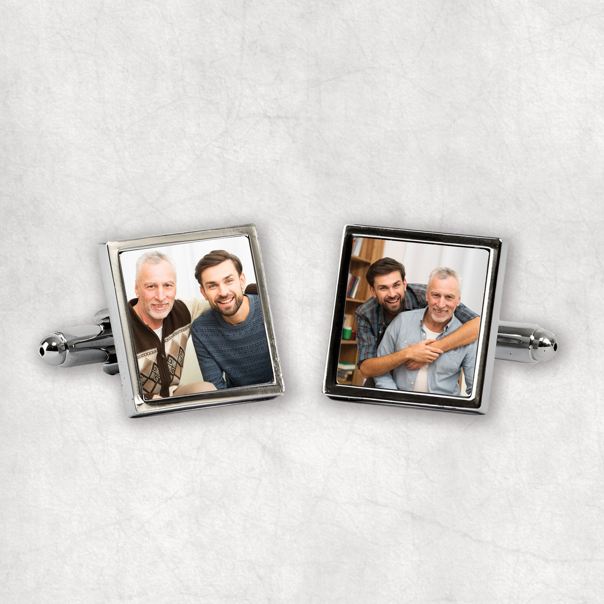 A pair of silver cufflinks featuring two separate personalised photos, placed on a white background.