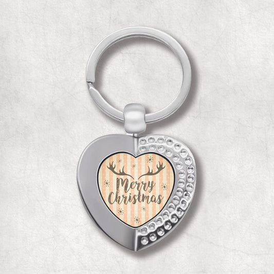 Heart-shaped keyring with Merry Christmas text on vintage background. The perfect gift for an elegant vintage person. 