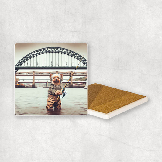 Ceramic Coaster gift with a Yorkshire Terrier dog design, dressed in an Angler costume, fishing in the Tyne river, with Newcastle bridges in the background.
