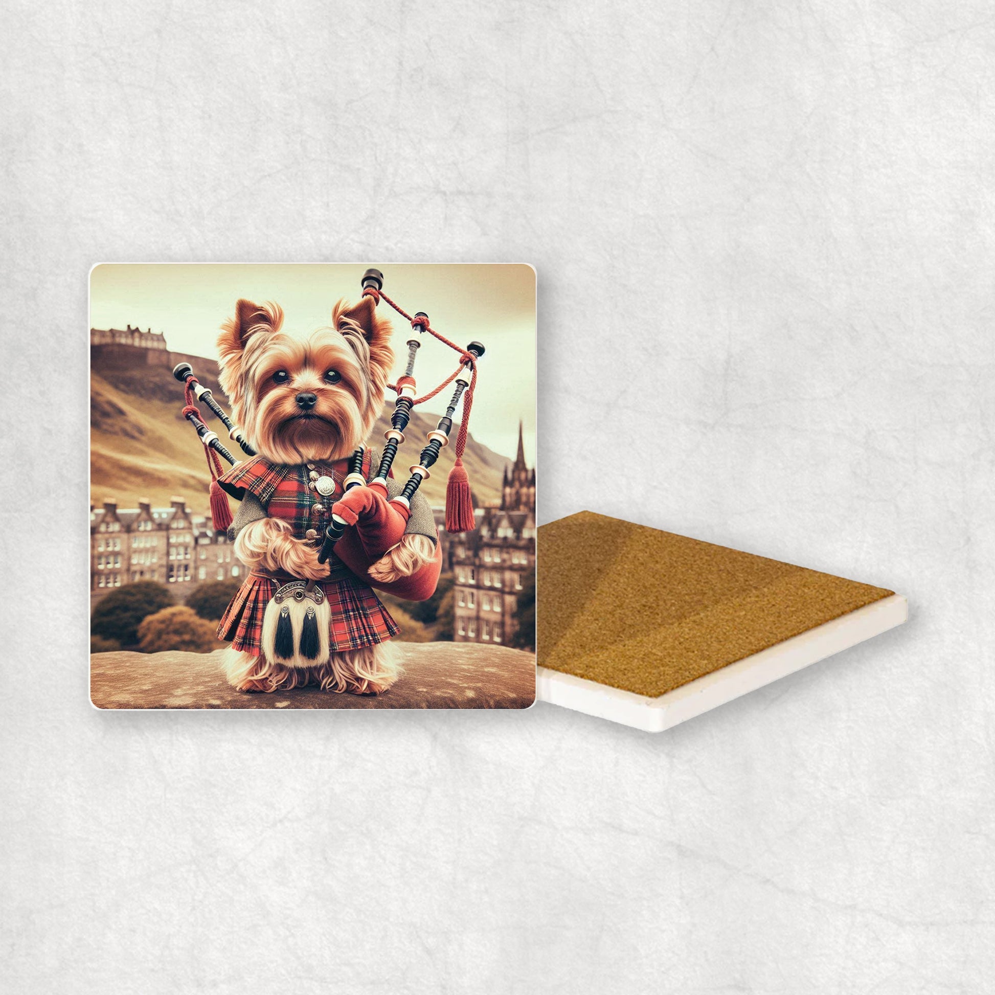 Ceramic Coaster gift with a Yorkshire Terrier dog design, dressed in traditional Scottish costume, playing the bagpipes, with Edinburgh in the background. 