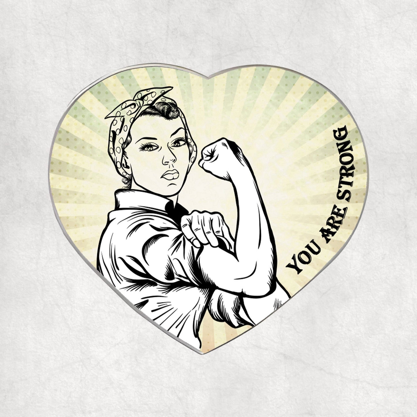Heart-shaped metal magnet with a woman flexing her arm design, with 'You Are Strong' text on a light vintage background.