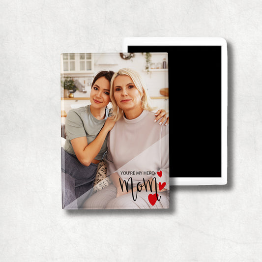 A ceramic vertical magnet with a personalised photo print, accompanied by the text 'Mom, You're my hero'.